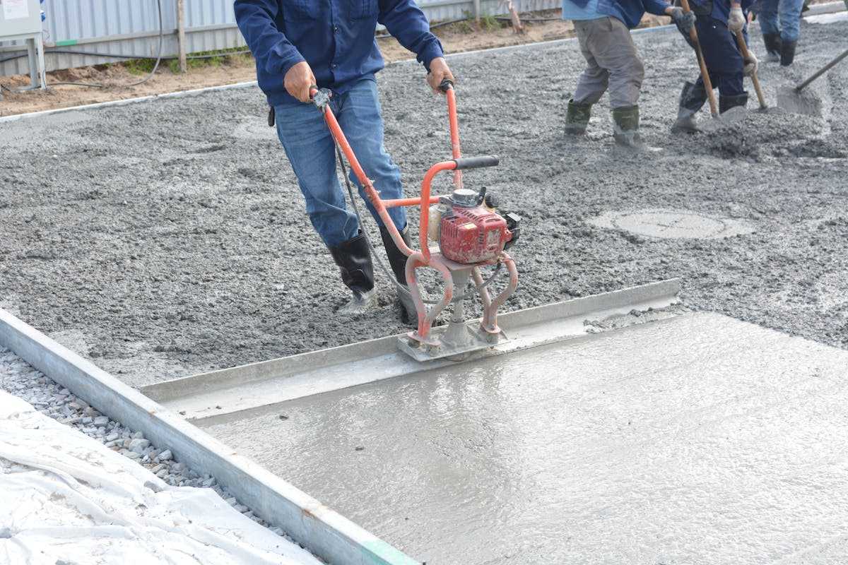 Workers finishing a fresh concrete slab